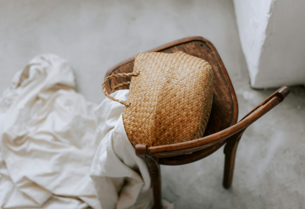 Styl Boho – wiklinowa torebka i drewniane krzesło